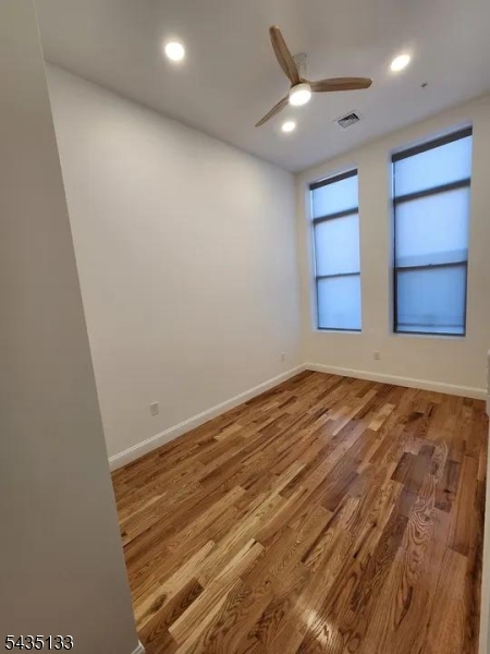 189 Main Street, Unit 3B Paterson, NJ 07505 - Photo 3 of 6 an empty room with a window and cabinet