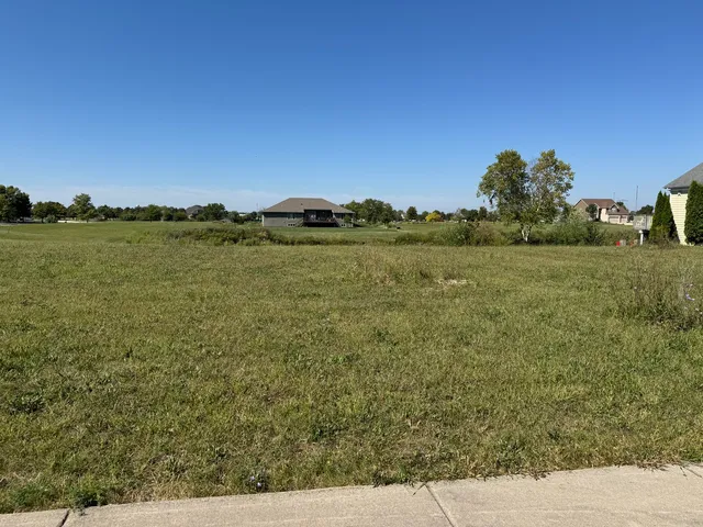 a view of a lake with houses in the back