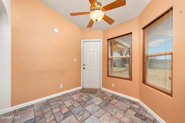 a view of a yard with wooden fence