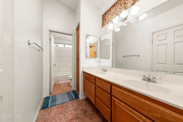 a spacious bathroom with a sink a toilet and shower