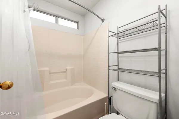 a bathroom with a shower and toilet