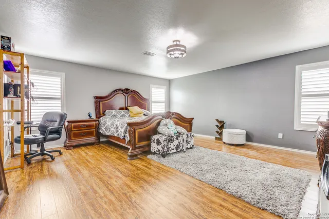 a view of a hallway with wooden floor and furniture