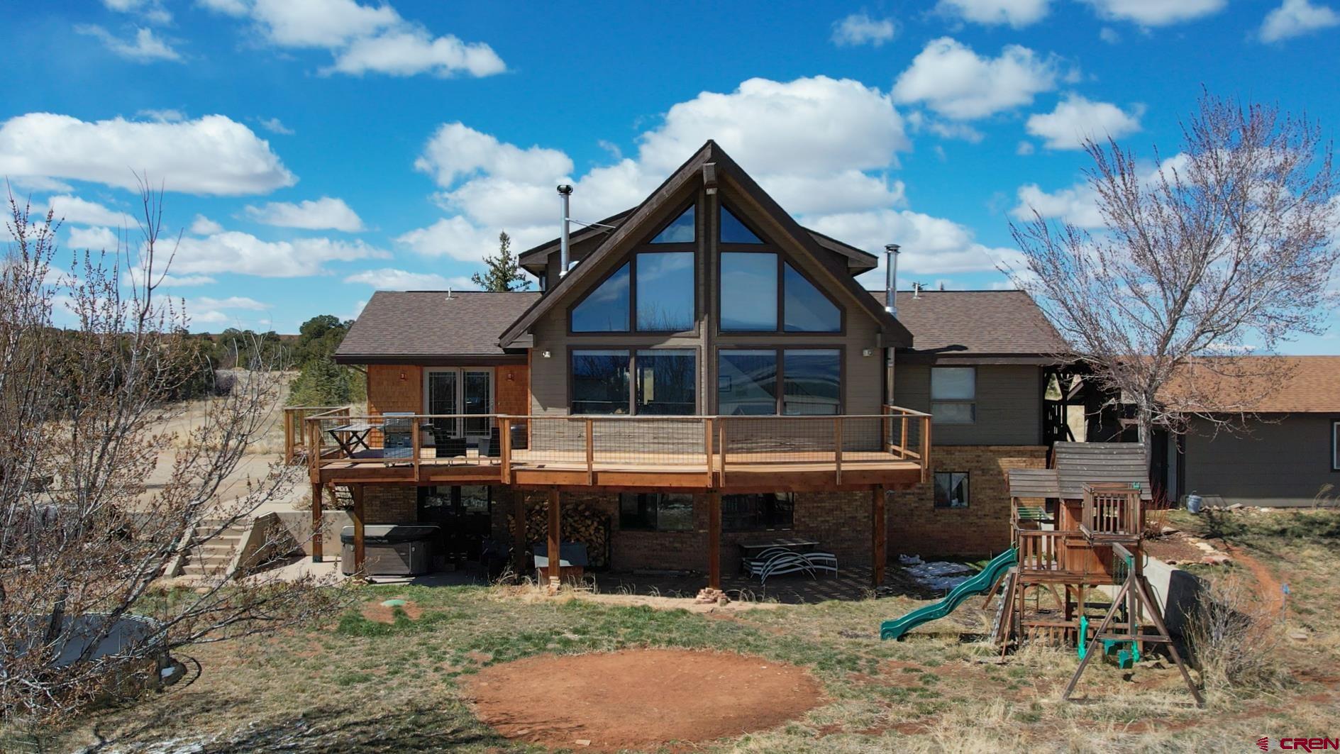 a view of house with yard outdoor seating and barbeque oven
