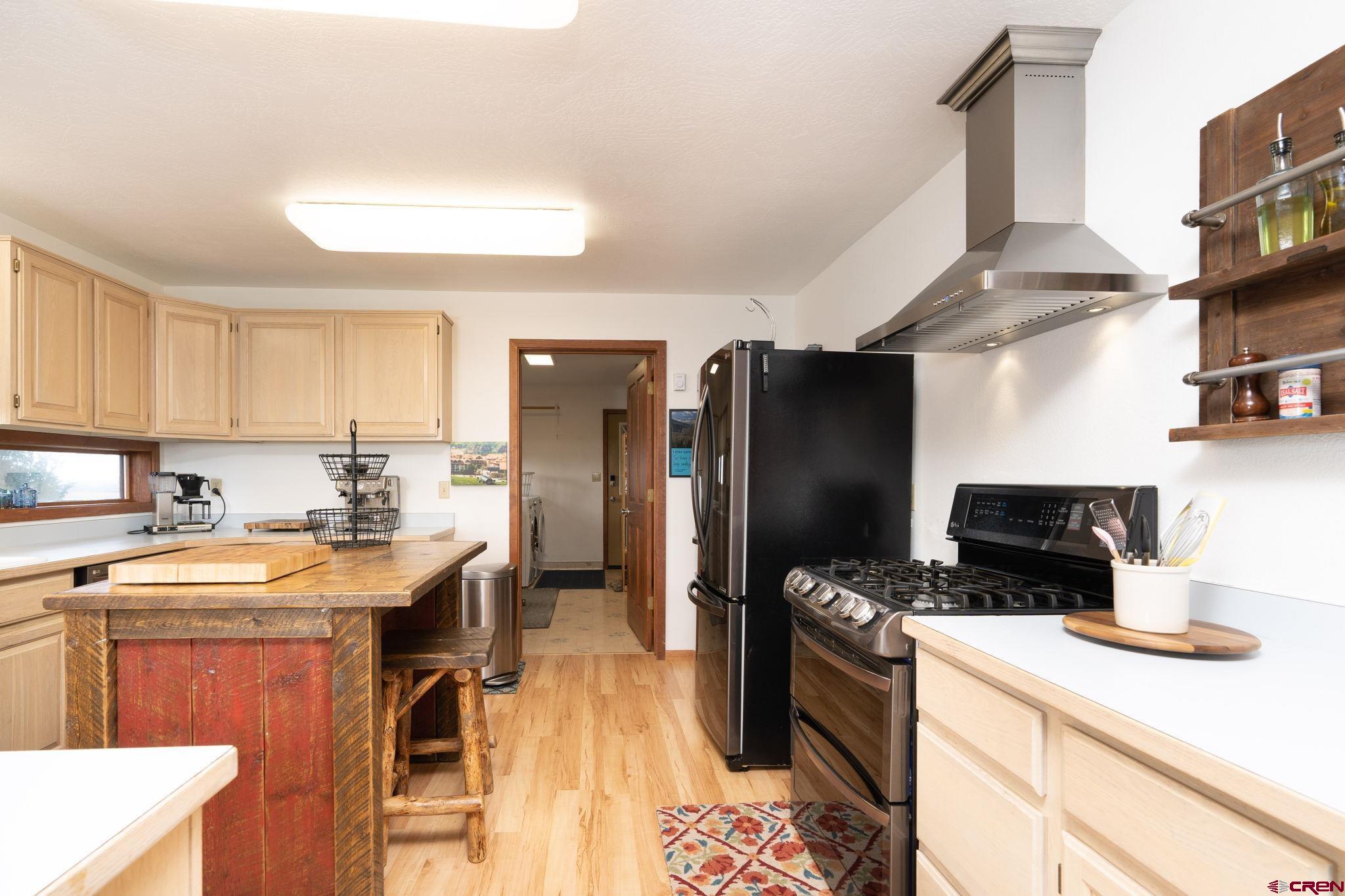 12190 Road 16 Cortez, CO 81321 - Photo 11 of 31 a kitchen with stainless steel appliances granite countertop a refrigerator stove and sink