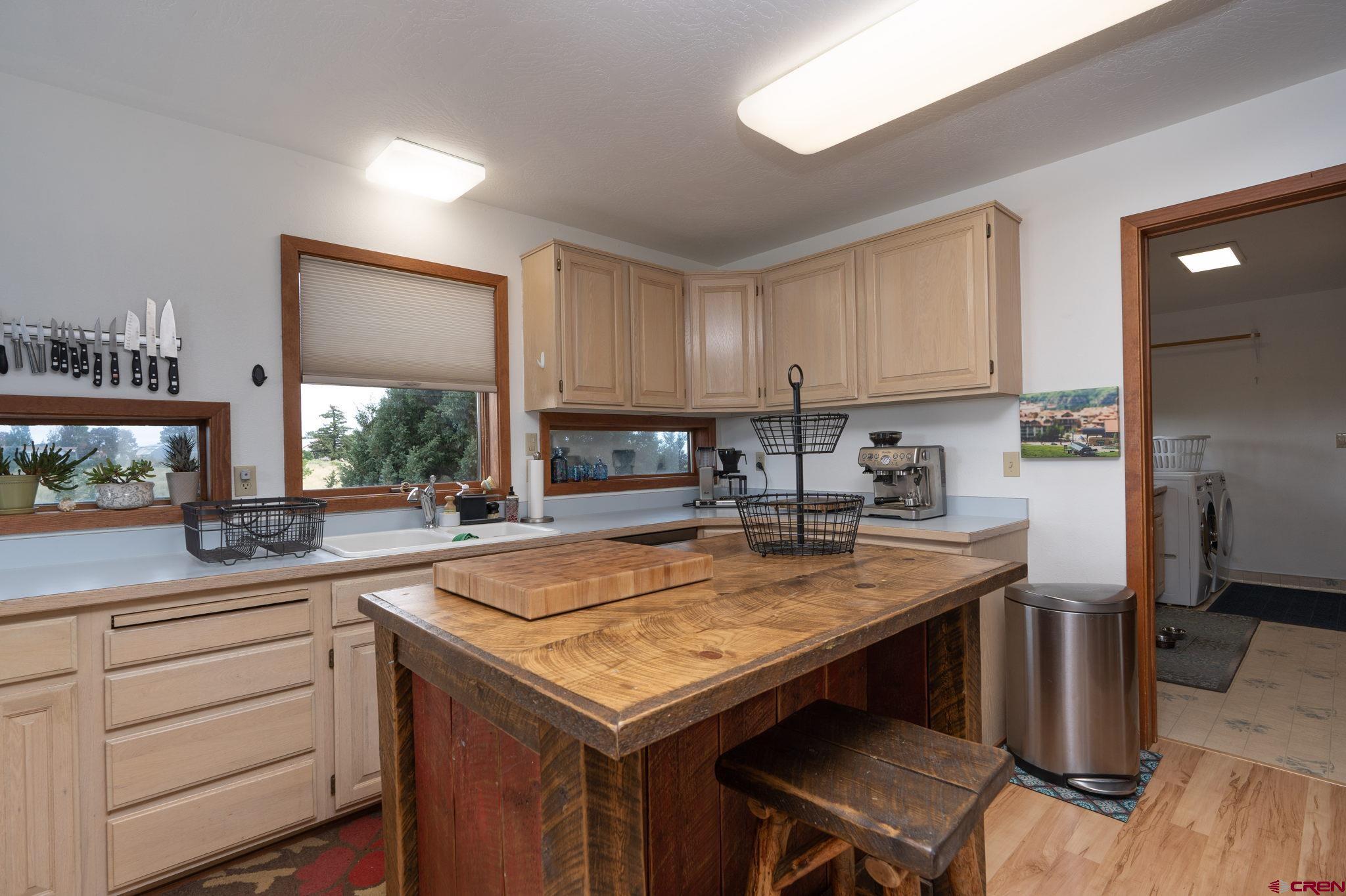 12190 Road 16 Cortez, CO 81321 - Photo 13 of 31 a kitchen with a sink a stove a refrigerator and cabinets