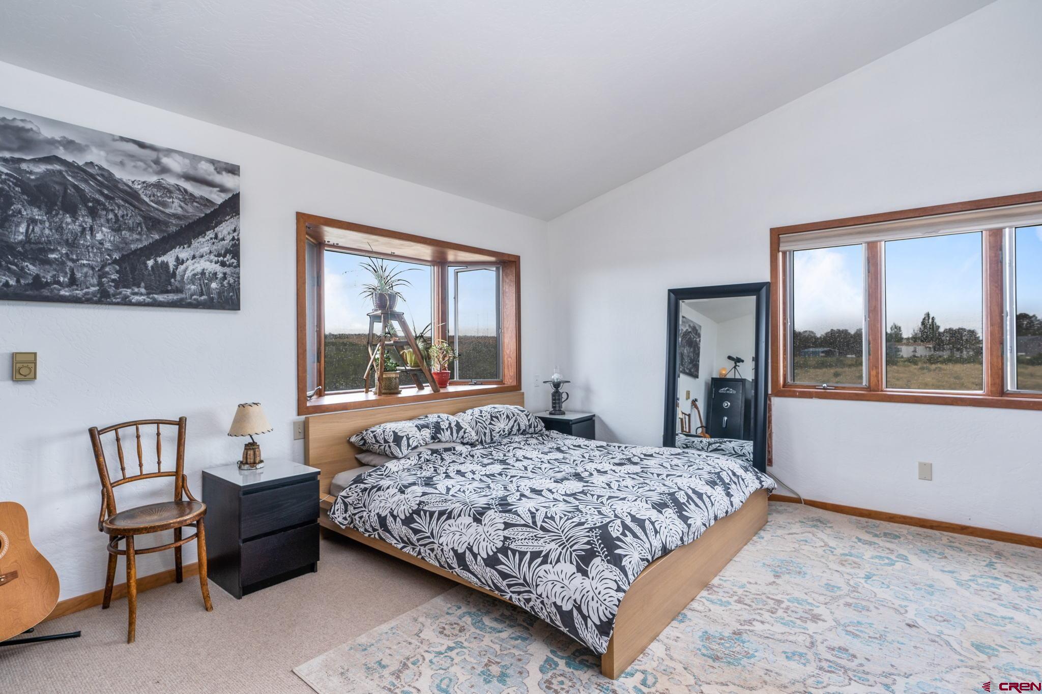 12190 Road 16 Cortez, CO 81321 - Photo 15 of 31 a bedroom with a large bed and a window