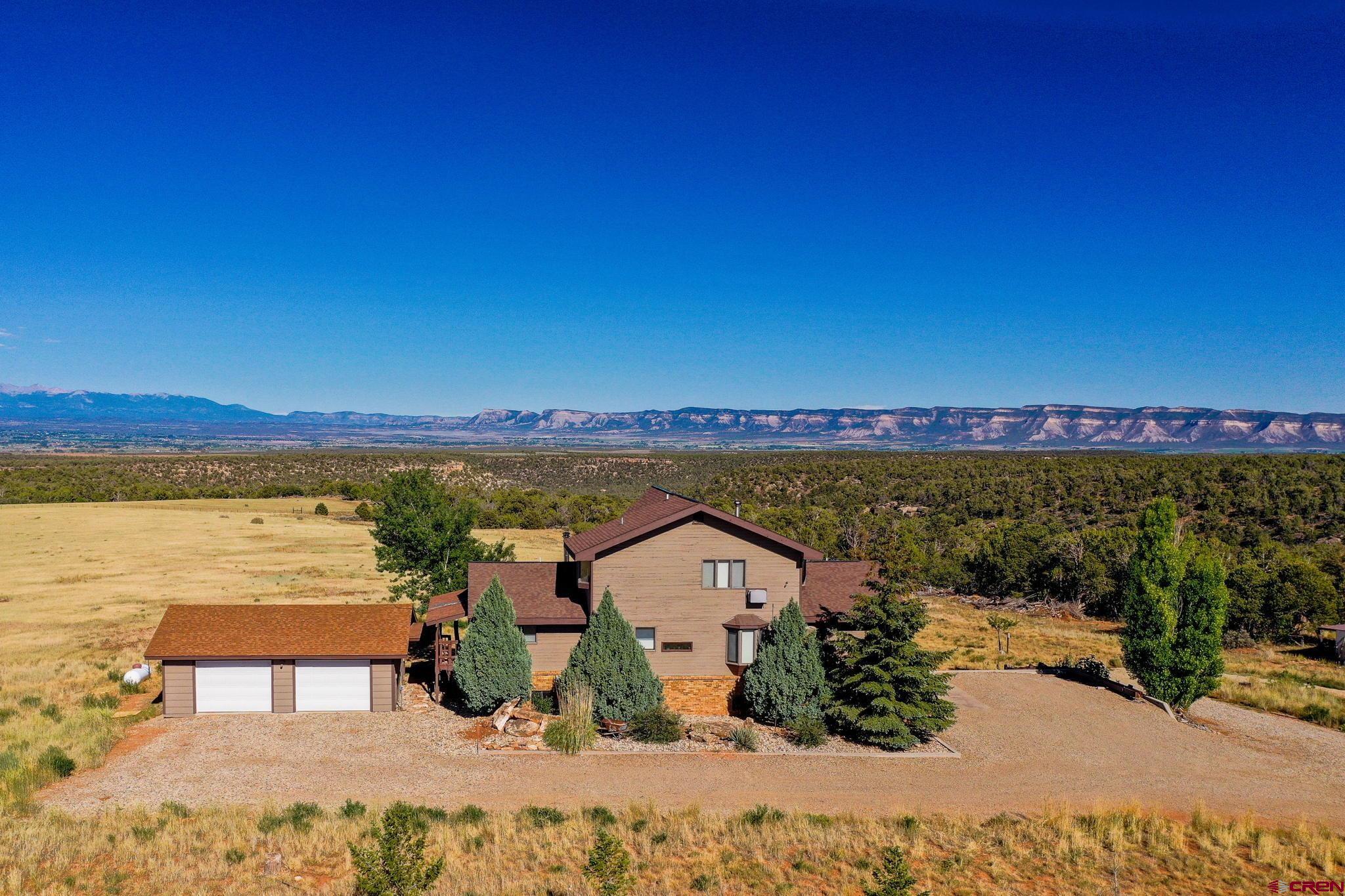 12190 Road 16 Cortez, CO 81321 - Photo 2 of 31 a view of a lake with a house in the background