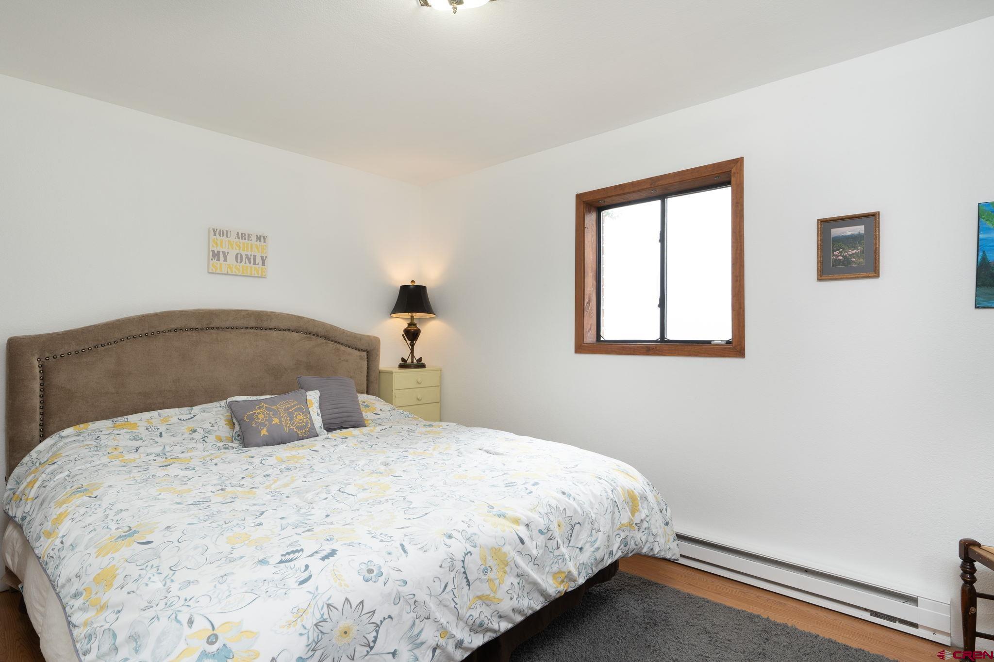 12190 Road 16 Cortez, CO 81321 - Photo 21 of 31 a bedroom with a bed and a window
