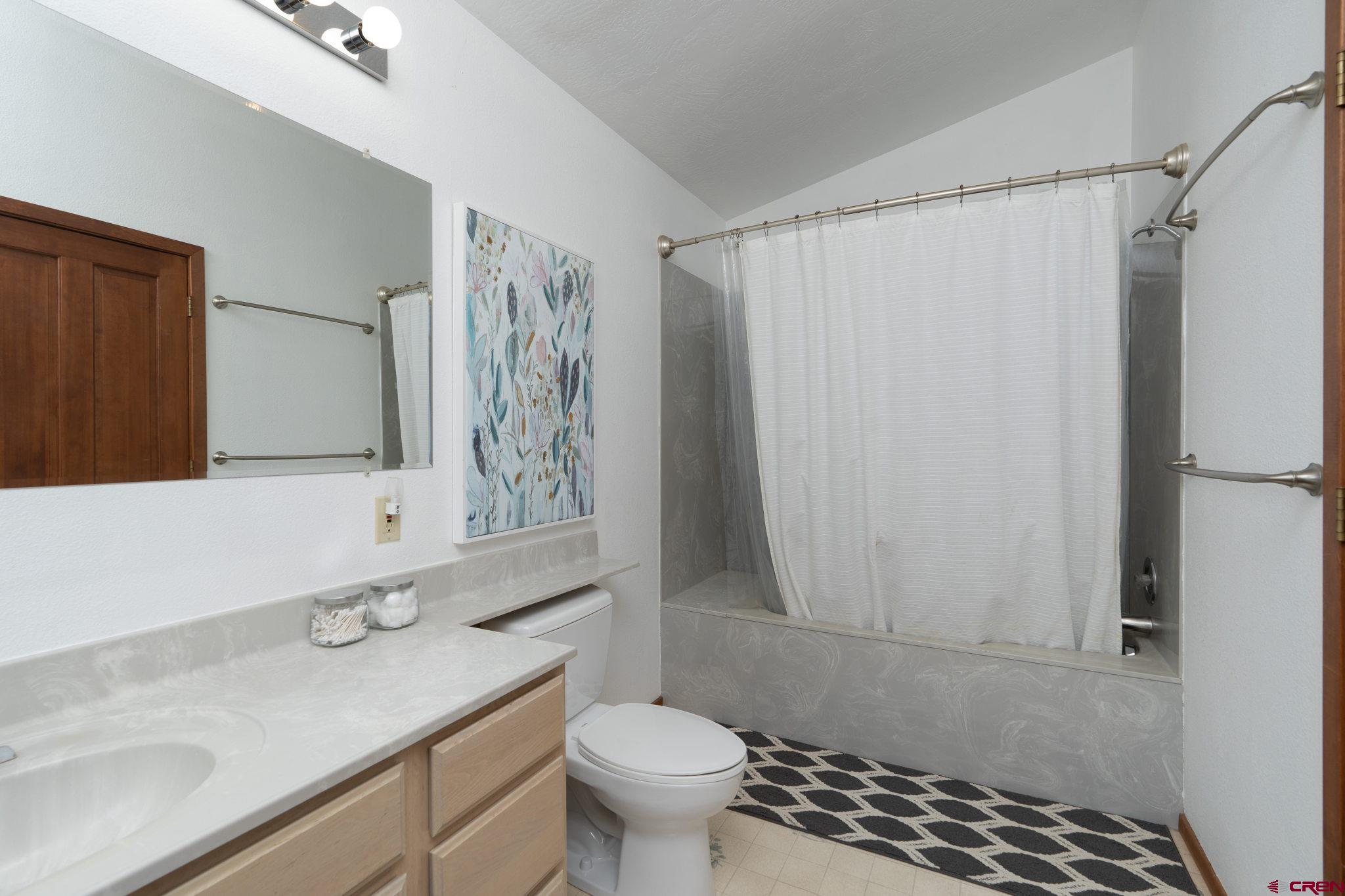 12190 Road 16 Cortez, CO 81321 - Photo 22 of 31 a bathroom with a sink a toilet and shower