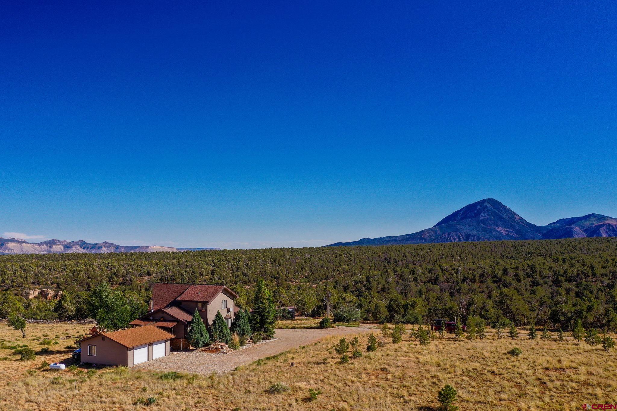 12190 Road 16 Cortez, CO 81321 - Photo 3 of 31 a view of a terrace with a table and chairs under an umbrella