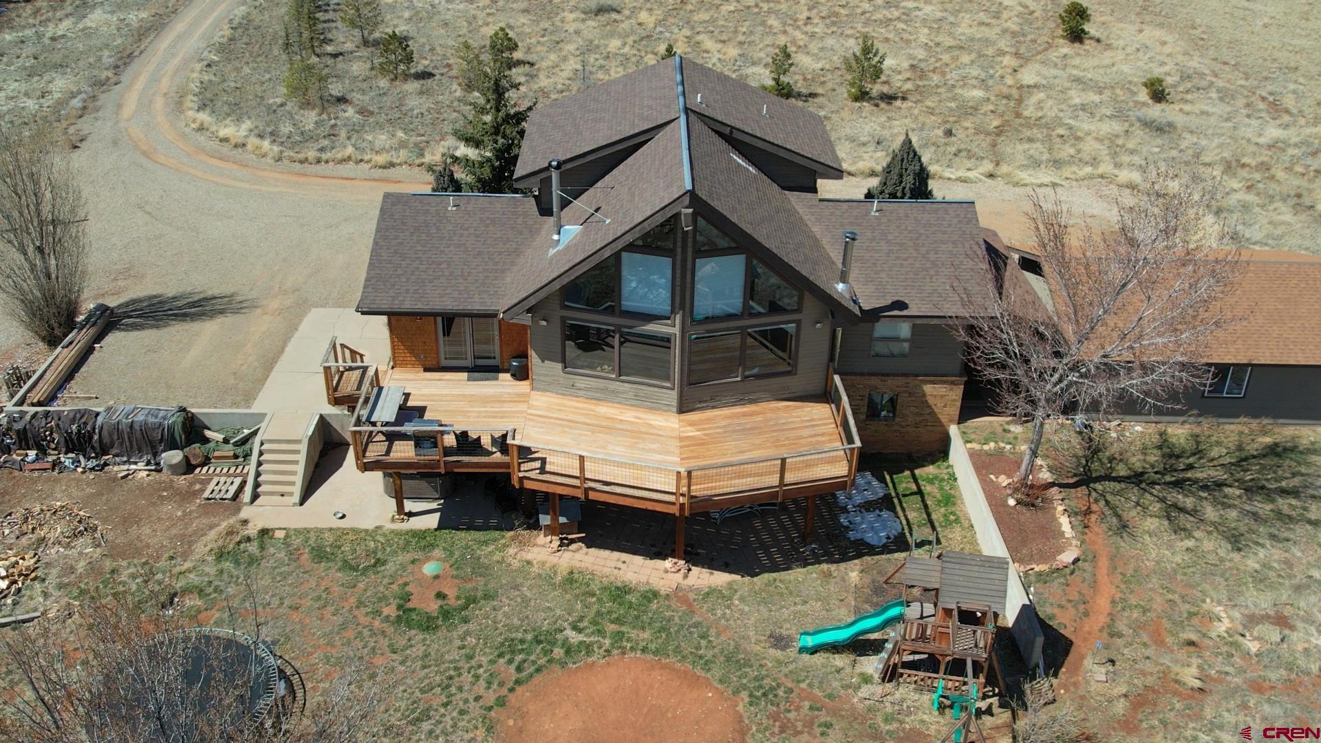 12190 Road 16 Cortez, CO 81321 - Photo 4 of 31 an aerial view of a house with swimming pool and sitting space