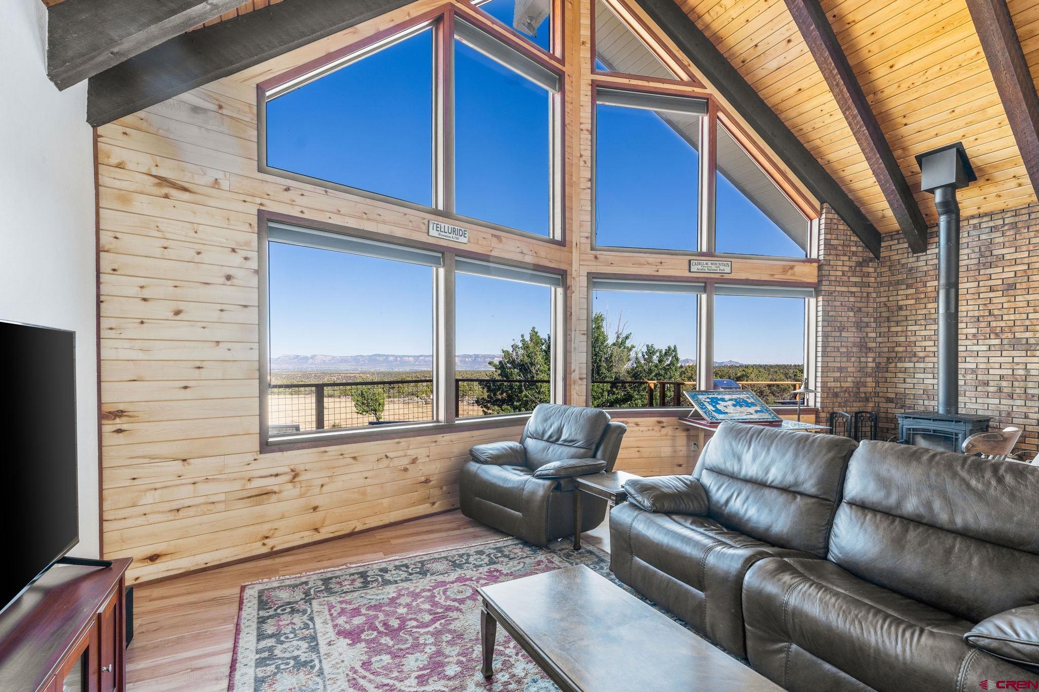 12190 Road 16 Cortez, CO 81321 - Photo 7 of 31 a living room with furniture wooden floor and a large window