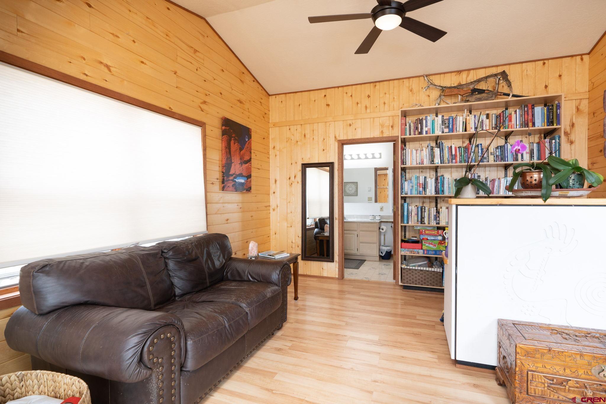 12190 Road 16 Cortez, CO 81321 - Photo 9 of 31 a living room with furniture and a book shelf