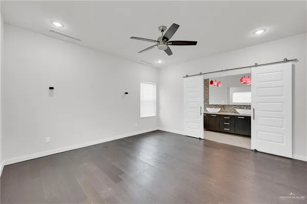 a bathroom with a granite countertop sink a mirror and a bathtub