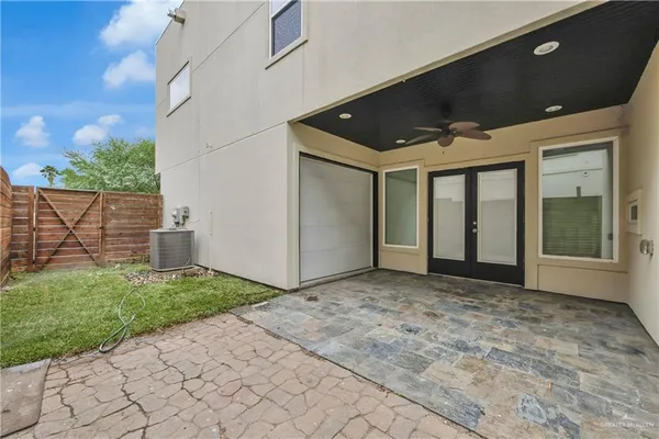 a view of a tennis ground with large trees