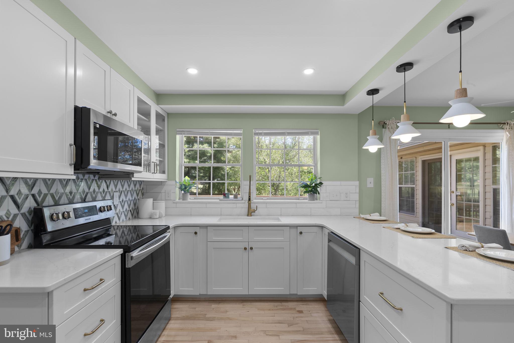 15809 Chagall Terrace North Potomac, MD 20878 - Photo 11 of 37 a kitchen with a sink stove and microwave