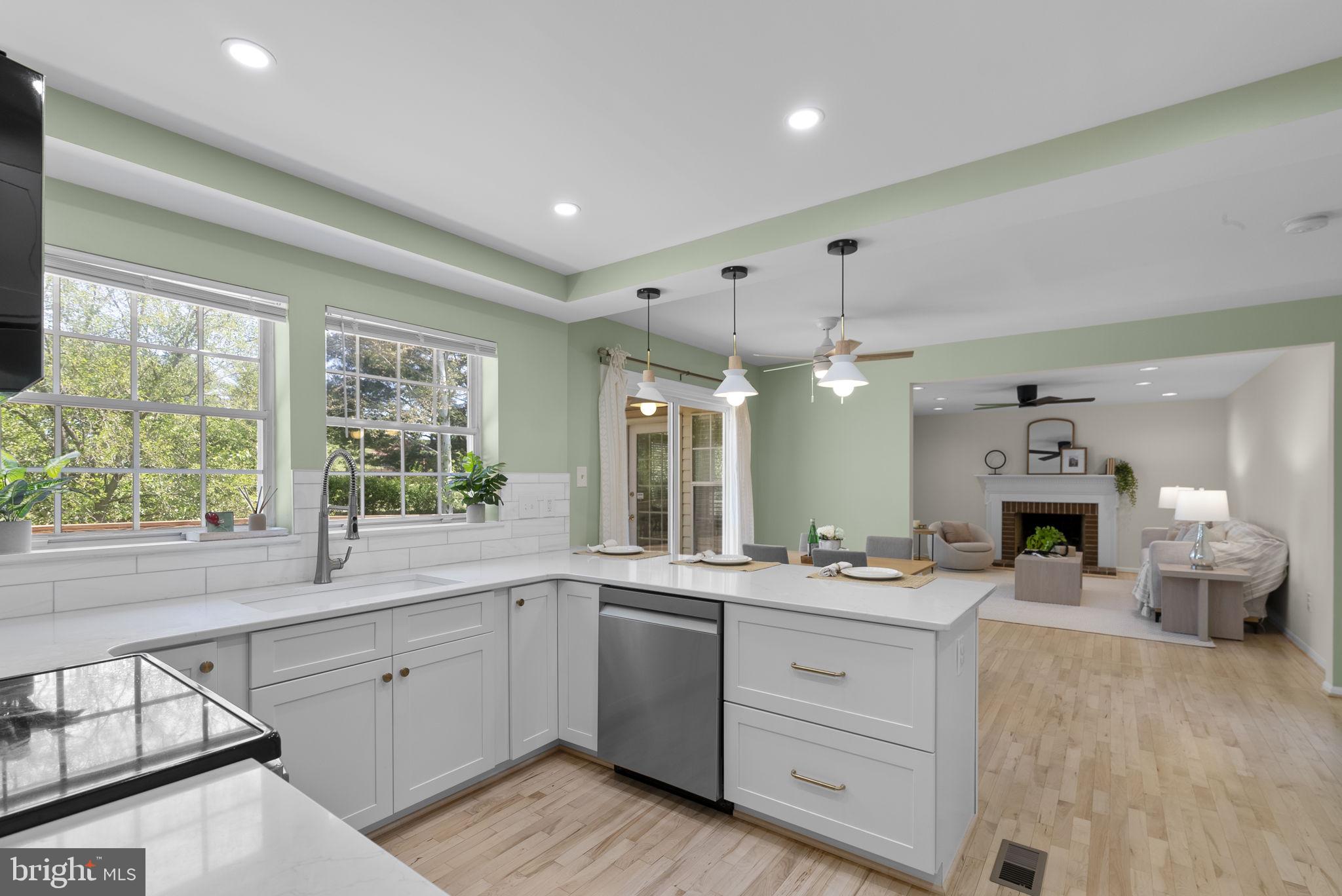 15809 Chagall Terrace North Potomac, MD 20878 - Photo 12 of 37 a large white kitchen with a large window and stainless steel appliances