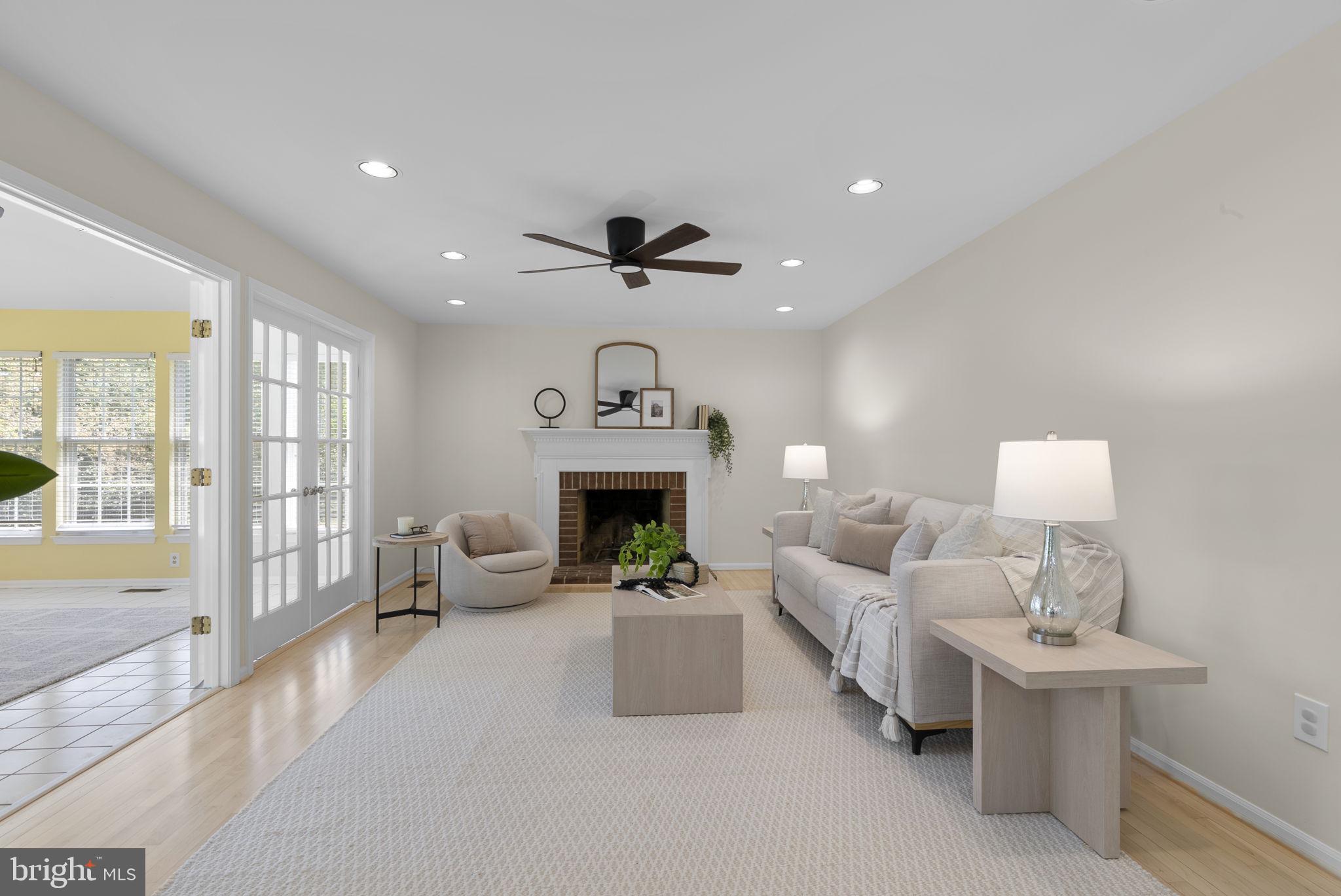15809 Chagall Terrace North Potomac, MD 20878 - Photo 14 of 37 a living room with furniture a fireplace and a chandelier