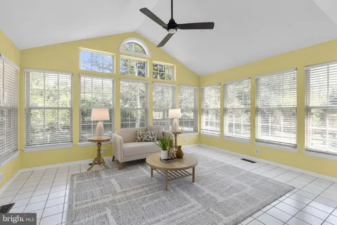 a living room with furniture and a floor to ceiling window