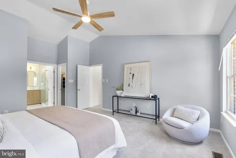 a bedroom with a bed and a chair