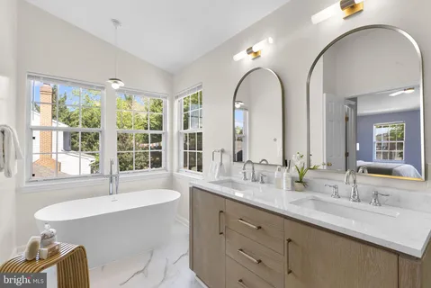 a bathroom with a double vanity sink and a large mirror