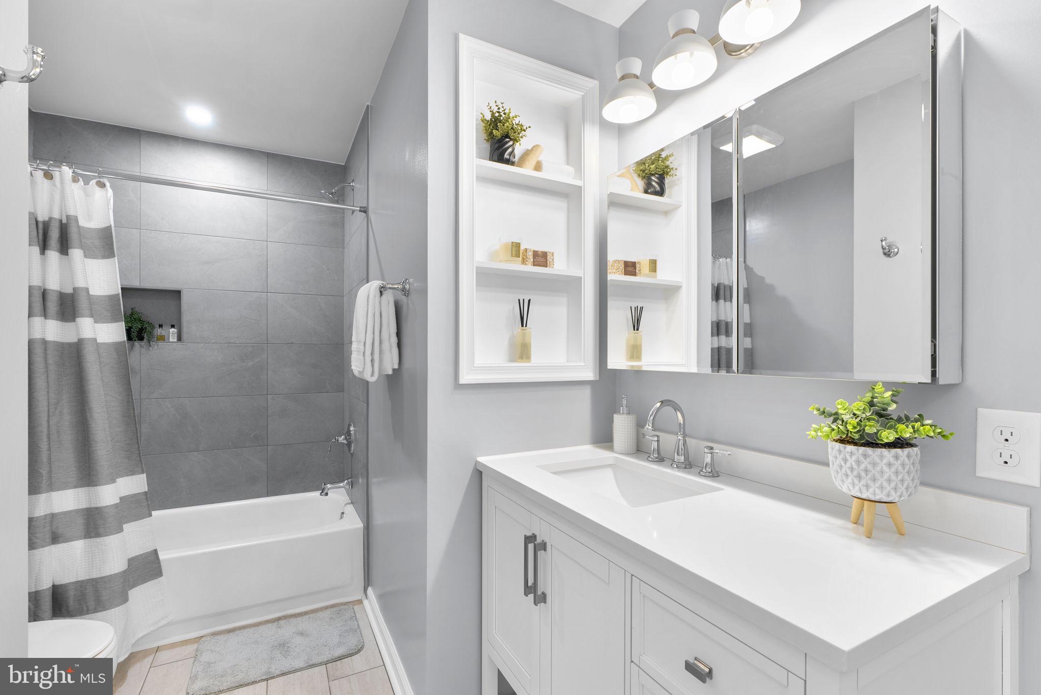 15809 Chagall Terrace North Potomac, MD 20878 - Photo 24 of 37 a bathroom with a bathtub sink and mirror