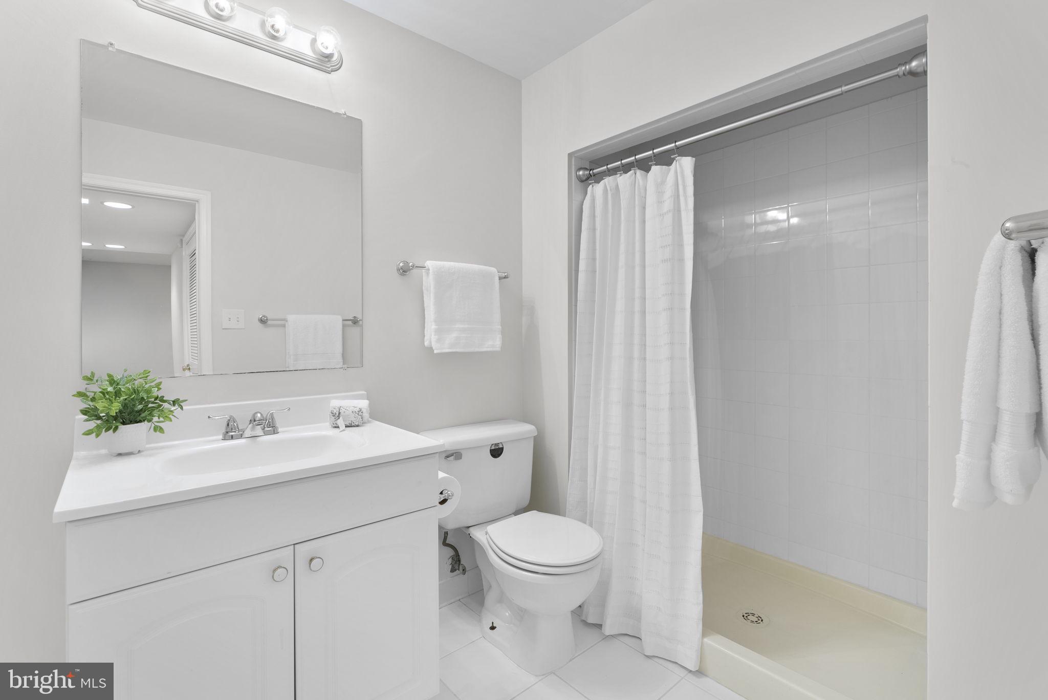 15809 Chagall Terrace North Potomac, MD 20878 - Photo 28 of 37 a bathroom with a sink a toilet and shower
