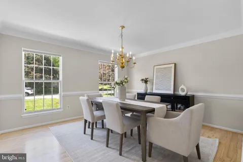 a view of a dining room with furniture and a chandelier