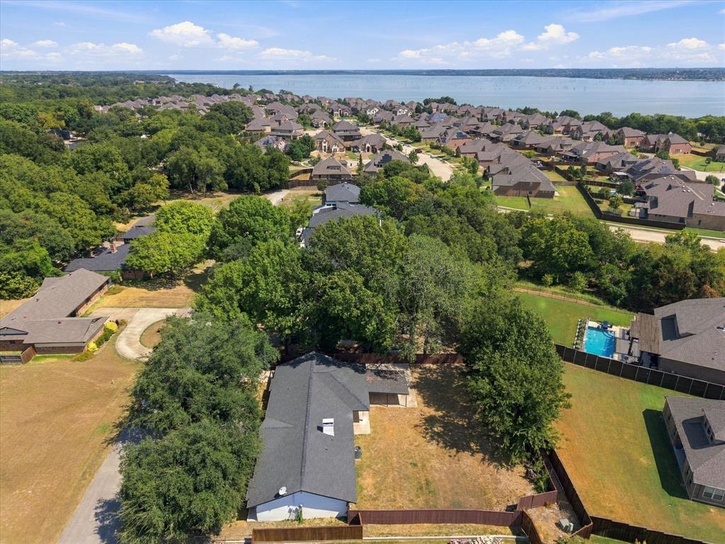 925 Lake North Road Rowlett, TX 75089 - Photo 31 of 37 Aerial perspective showcasing a residential neighborhood with mature trees and a body of water in the background