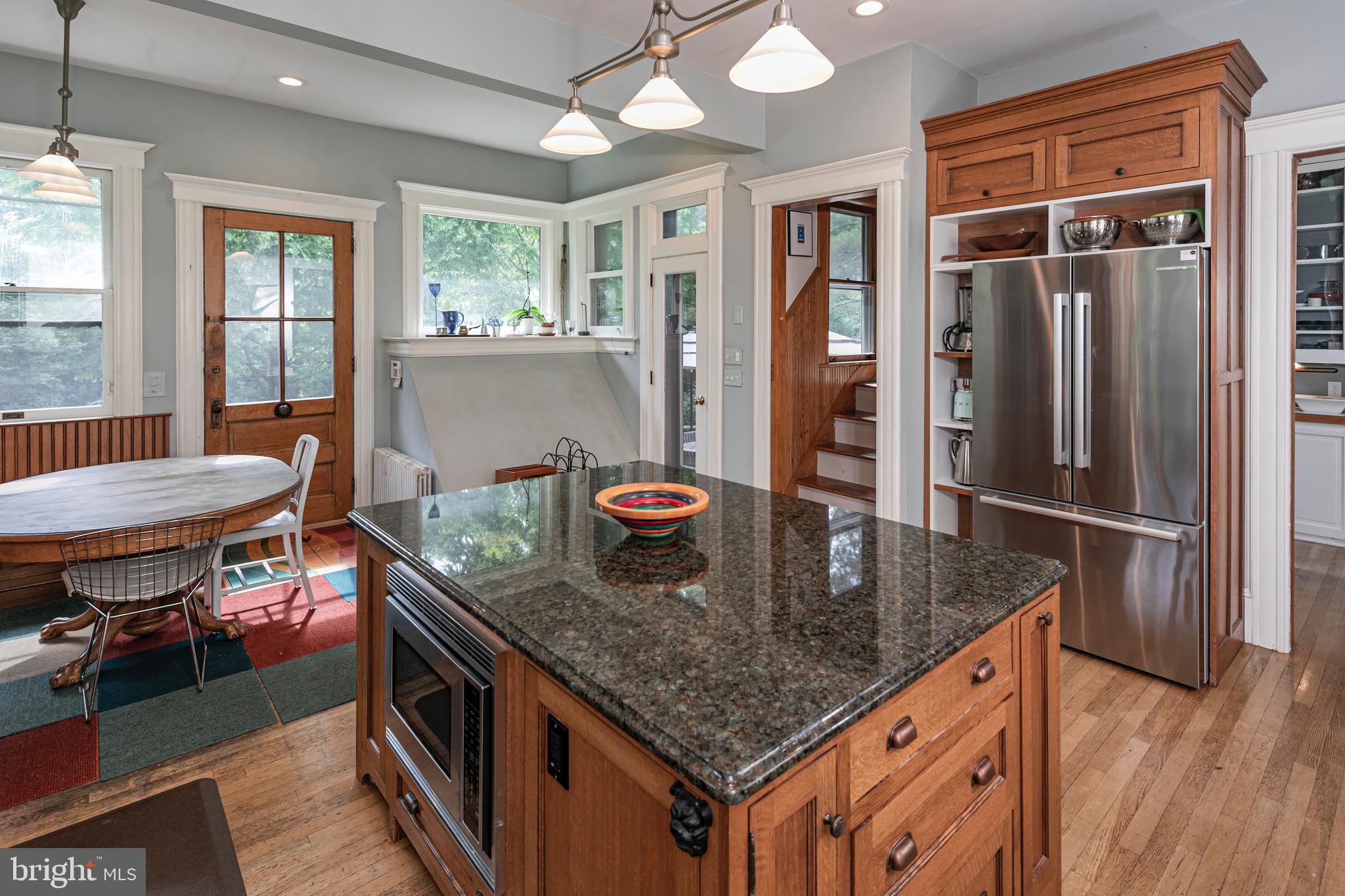 54 Hodge Road Princeton, NJ 08540 - Photo 18 of 51 a kitchen with stainless steel appliances granite countertop a stove and a dining table