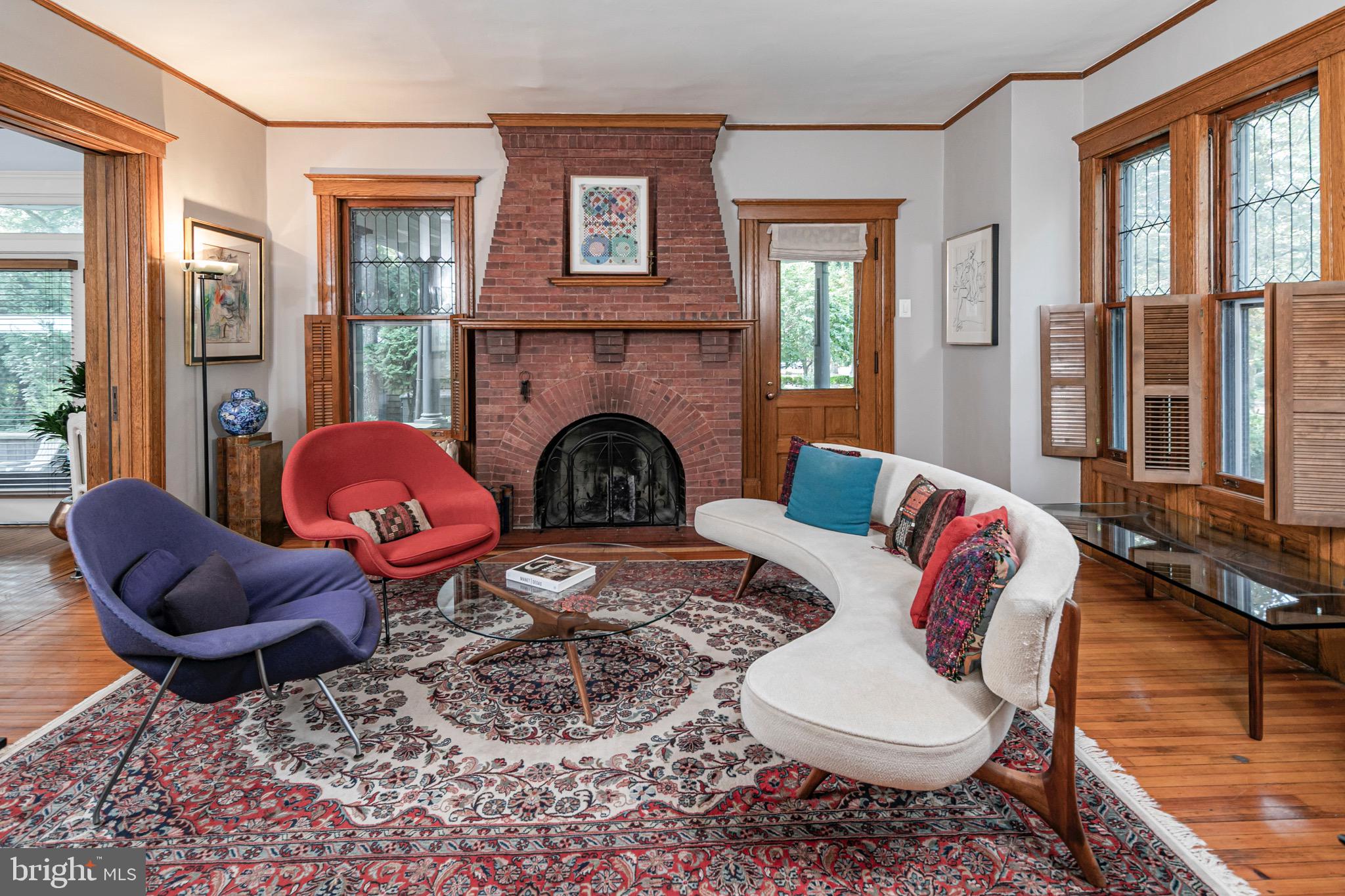 54 Hodge Road Princeton, NJ 08540 - Photo 9 of 51 a living room with furniture a fireplace and floor to ceiling windows