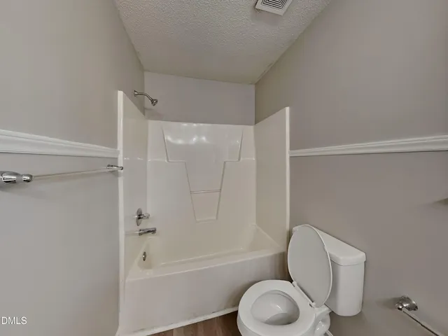 a bathroom with a toilet and a bathtub