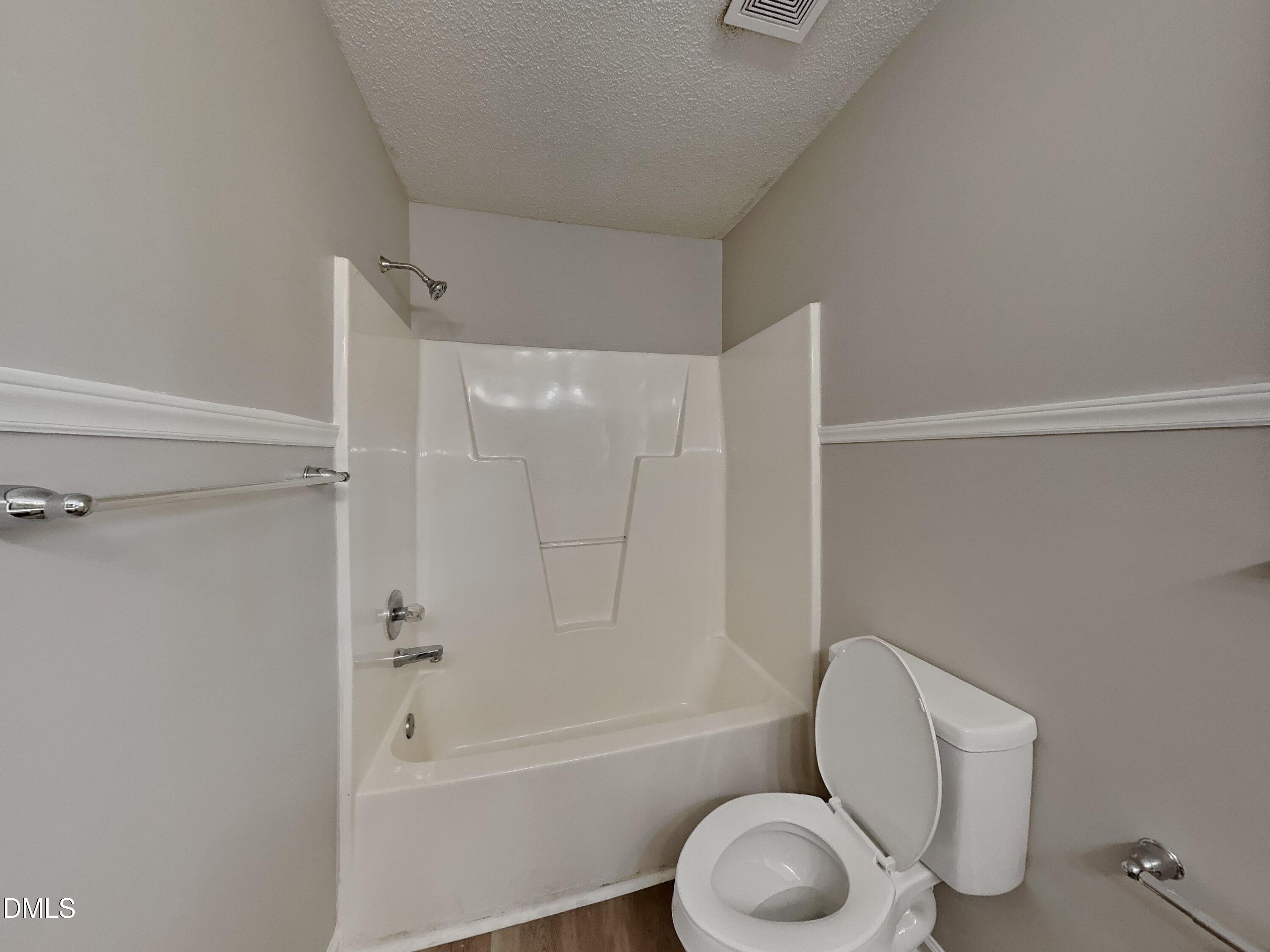 120 Hocutt Drive Clayton, NC 27520 - Photo 11 of 18 a bathroom with a toilet and a bathtub