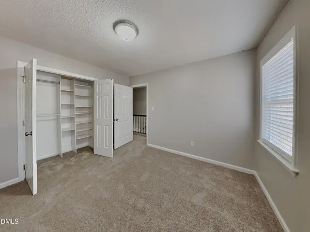 a view of an empty room with a closet
