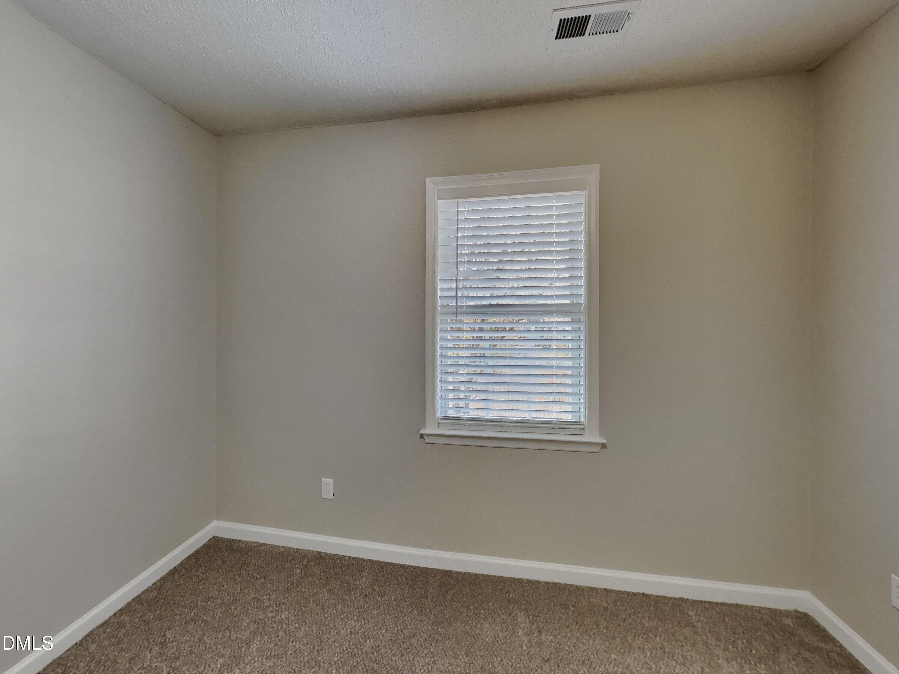 120 Hocutt Drive Clayton, NC 27520 - Photo 15 of 18 an empty room with a window