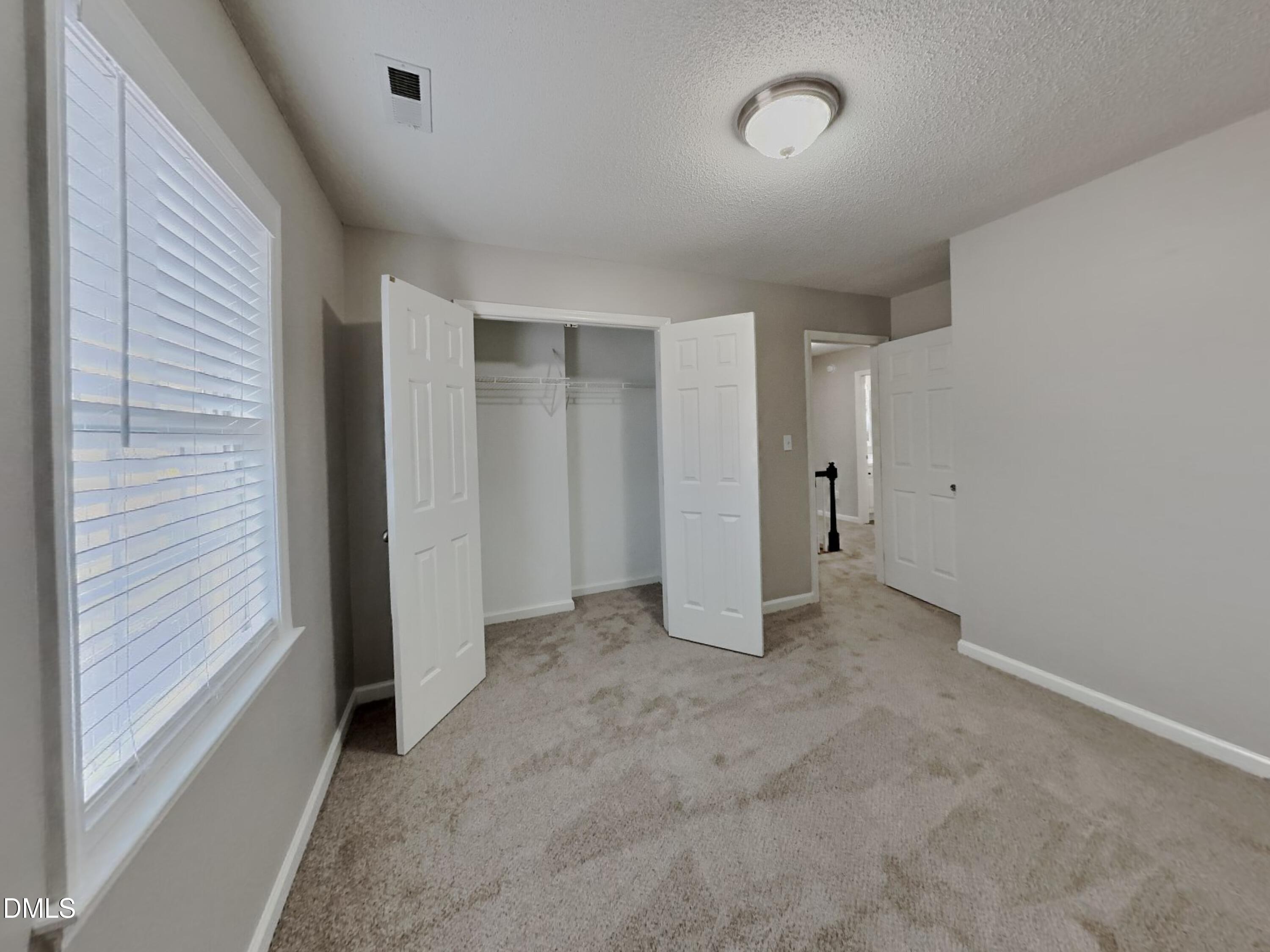 120 Hocutt Drive Clayton, NC 27520 - Photo 16 of 18 an empty room with a natural light