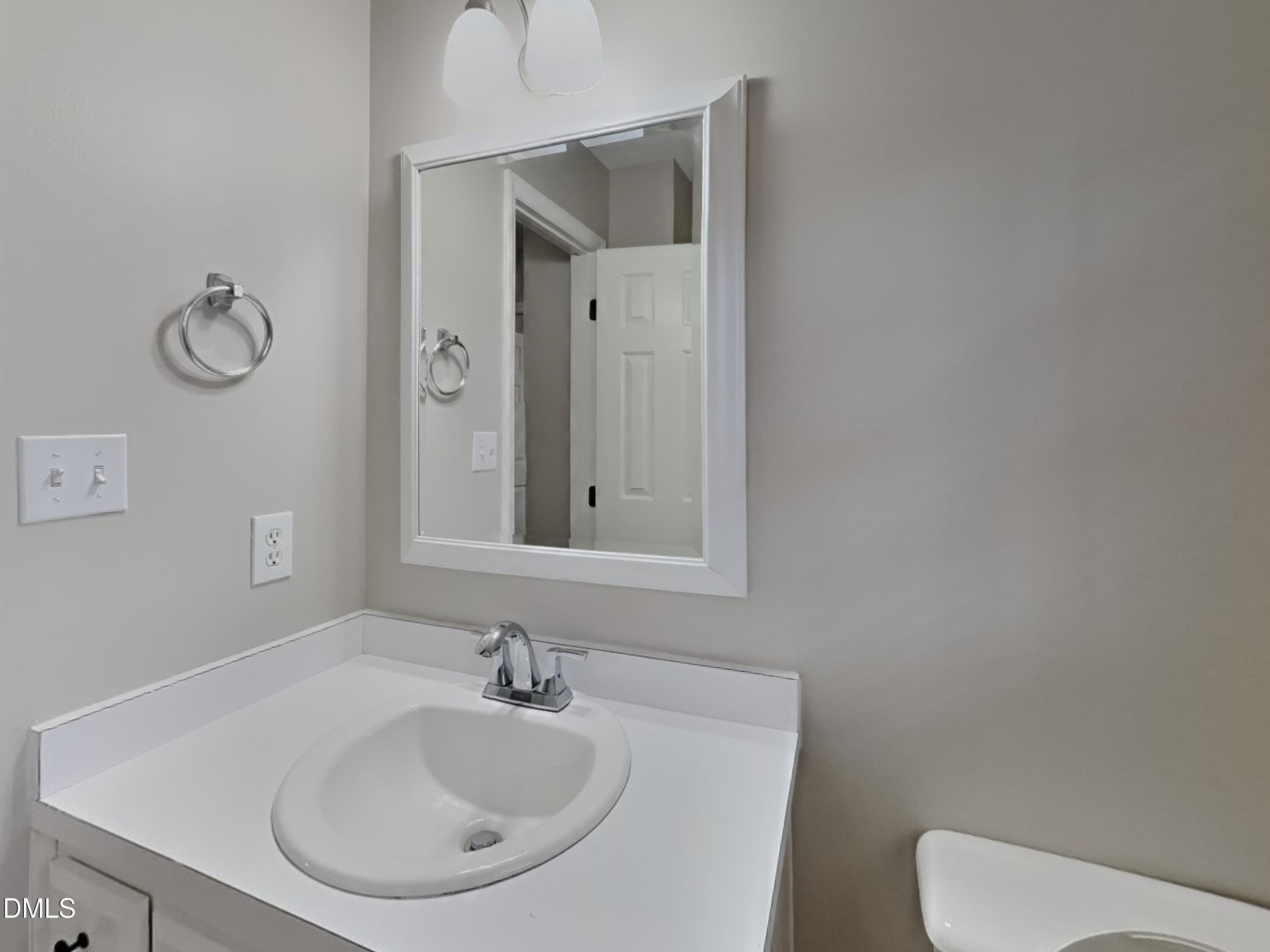 120 Hocutt Drive Clayton, NC 27520 - Photo 17 of 18 a bathroom with a toilet sink and mirror