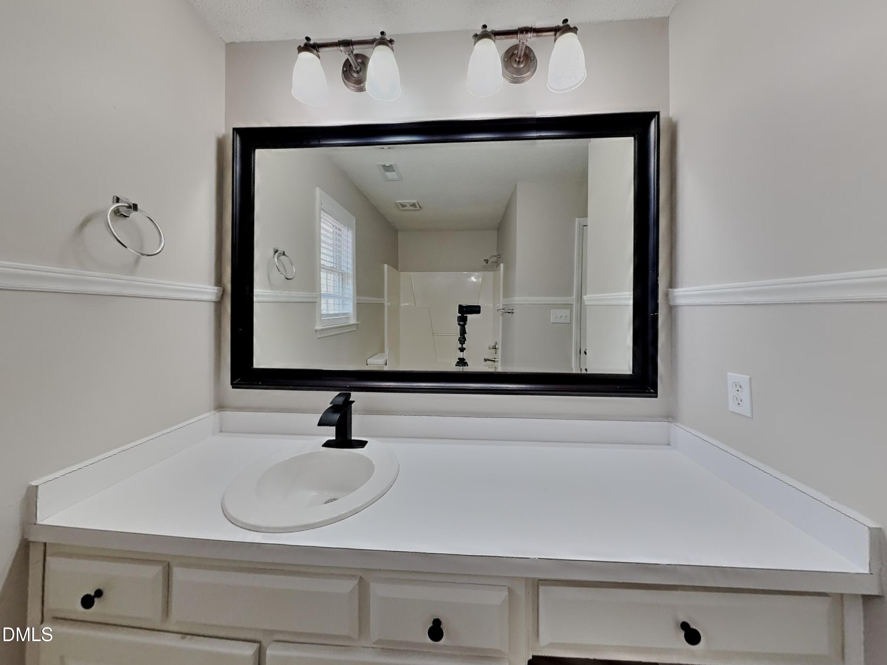120 Hocutt Drive Clayton, NC 27520 - Photo 10 of 18 a bathroom with a sink and a mirror