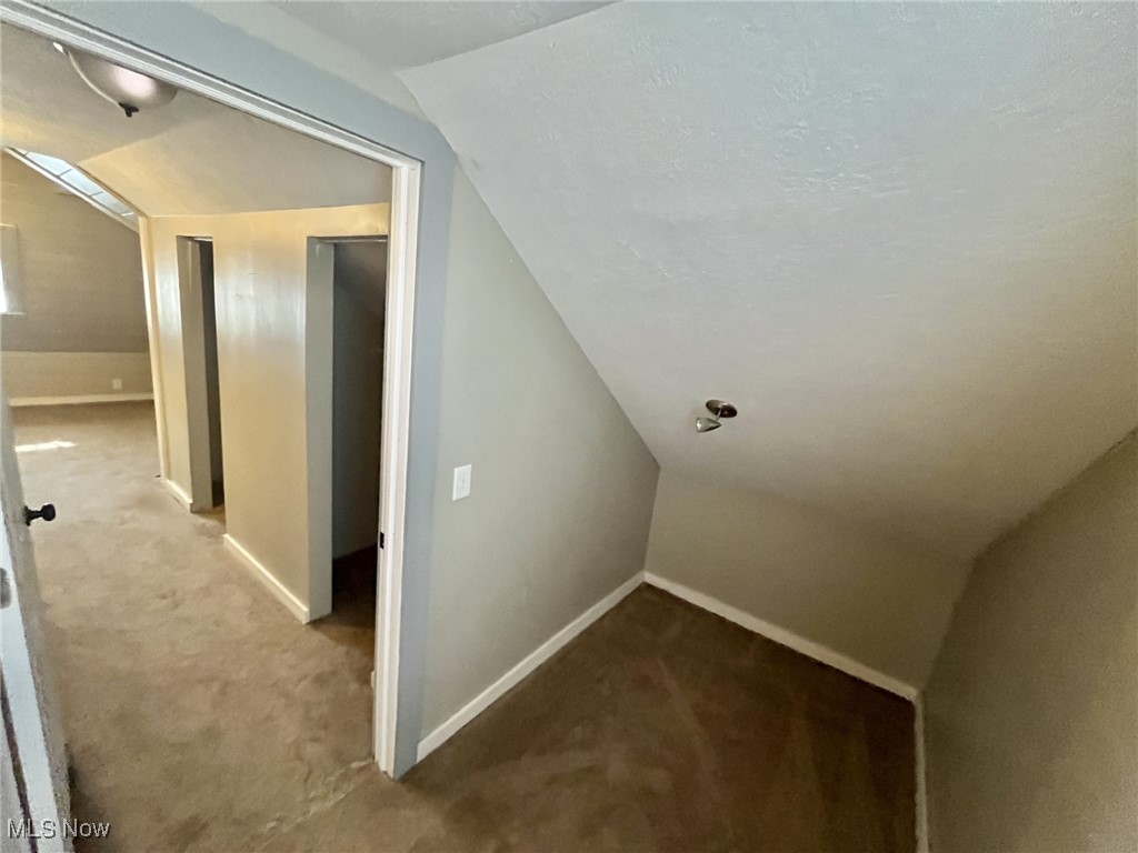 4440 Dryden Court Southwest Canton, OH 44708 - Photo 24 of 28 Additional living space with vaulted ceiling and carpet floors