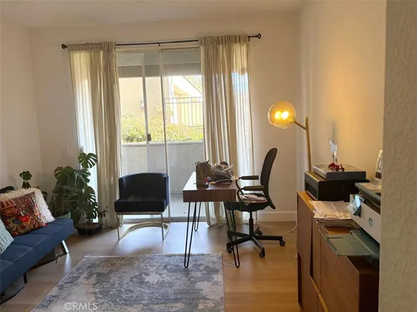 a work room with furniture and a large window