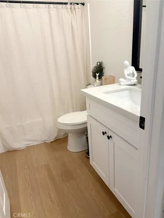 a bathroom with a sink a toilet and shower curtain