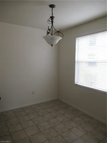 a view of a room with a window and a ceiling fan