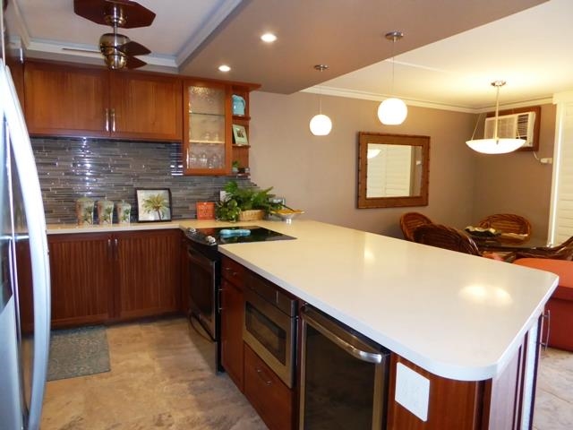 1032 South Kihei Road, Unit B420 Kihei, HI 96753 - Photo 6 of 47 a kitchen with stainless steel appliances a sink stove and cabinets