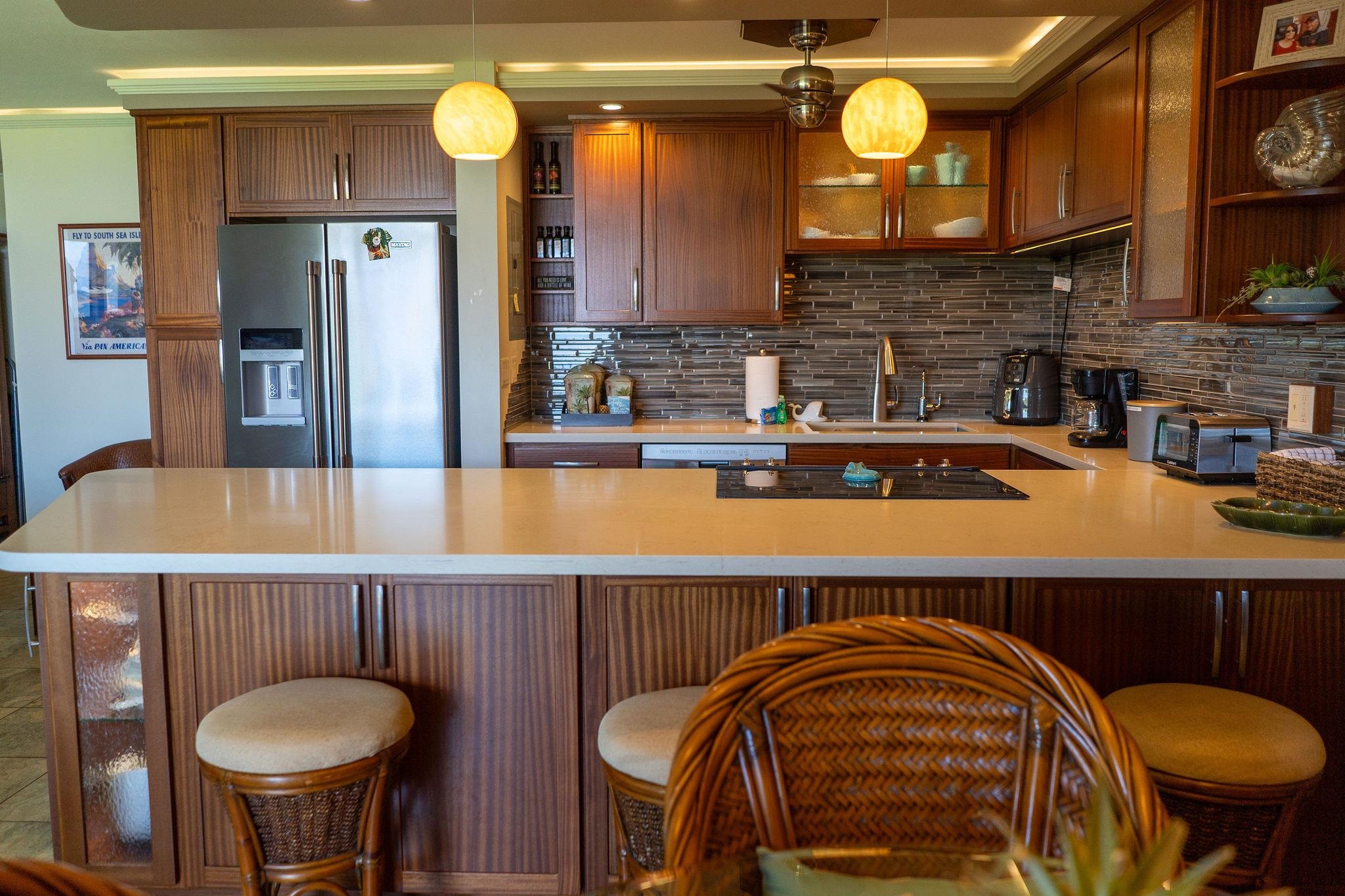 1032 South Kihei Road, Unit B420 Kihei, HI 96753 - Photo 7 of 47 a kitchen with stainless steel appliances granite countertop a sink and a refrigerator
