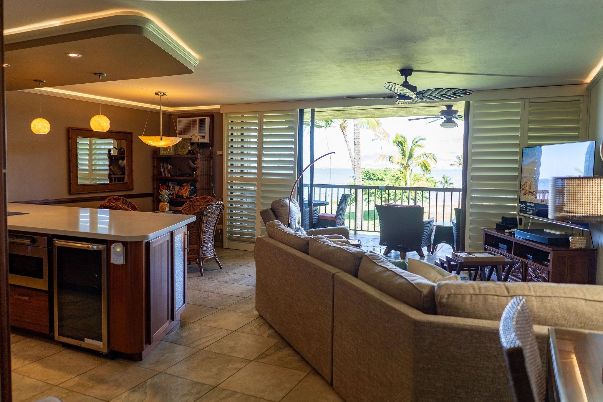1032 South Kihei Road, Unit B420 Kihei, HI 96753 - Photo 8 of 47 a living room with furniture a fireplace and a flat screen tv