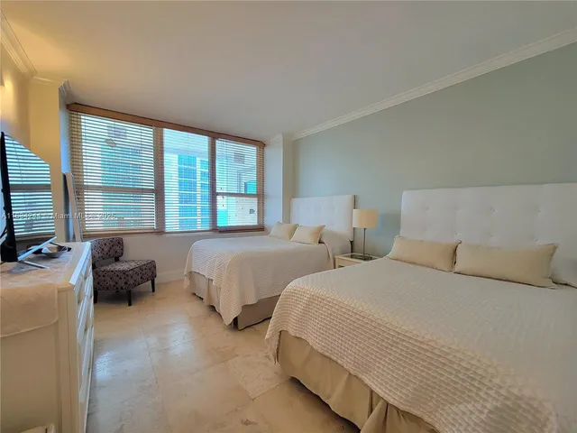 a bedroom with two beds and a couch