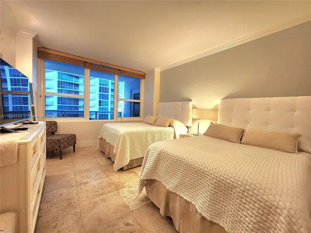 a spacious bedroom with a bed and a couch