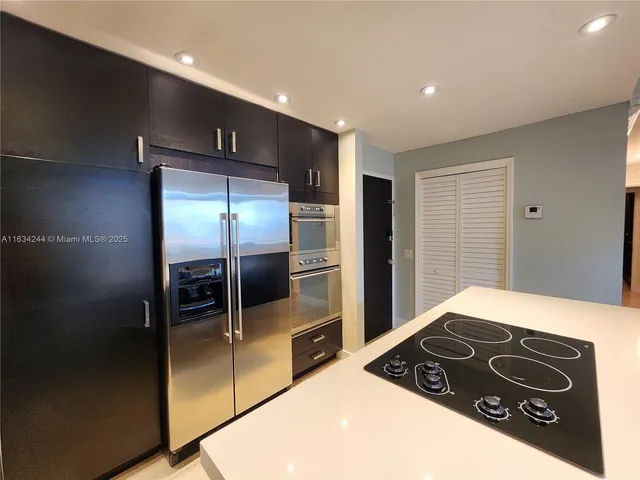 a kitchen with a stove a refrigerator and a kitchen counter top