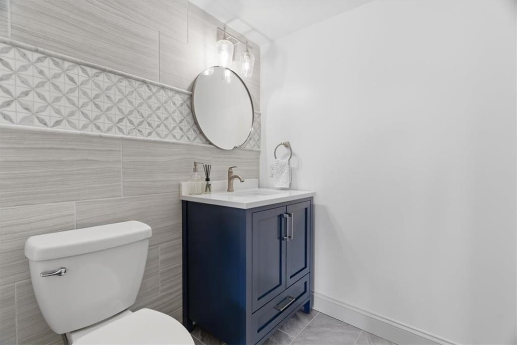 1 Pius Street, Unit B4 Pittsburgh, PA 15203 - Photo 18 of 41 a bathroom with a toilet sink vanity and mirror
