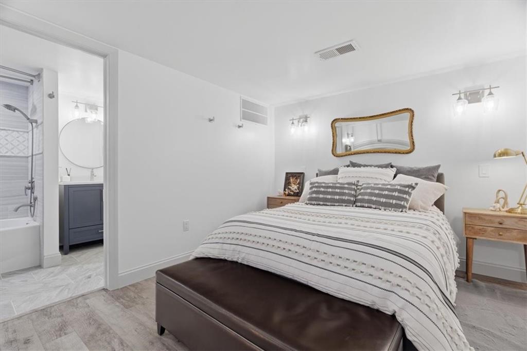 1 Pius Street, Unit B4 Pittsburgh, PA 15203 - Photo 28 of 41 a bedroom with a bed and a painting on the wall